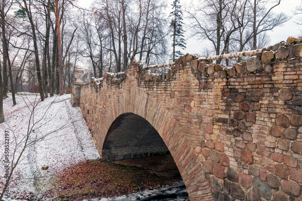 Ruin the bridge in the Alexandria park, frosty November day. The first snow.