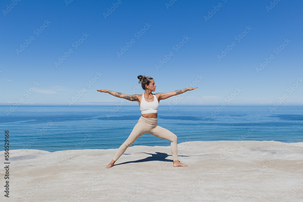 Warrior 2 pose Virabhadrasana II yoga on the beach Warrior 2 pose Virabhadrasana II yoga on the beach