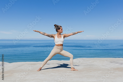 Warrior 2 pose Virabhadrasana II yoga on the beach