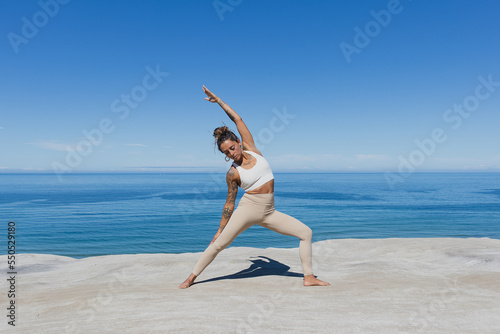 Warrior 2 side stretch yoga on the beach