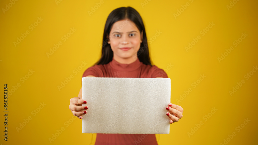 Beautiful young woman holding empty blank white board, your text here concept, Asian Indian girl isolated over colour background studio Beautiful young woman holding empty blank white board, your text here concept, Asian Indian girl isolated over colour background studio