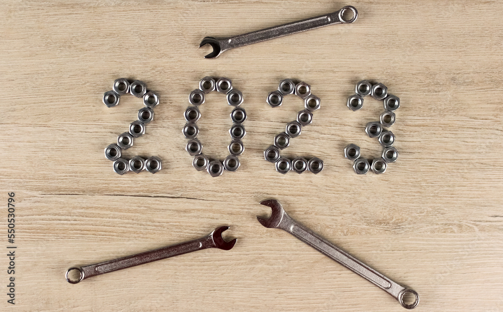 Number 2023 by metal nuts with wrenches. 2023 year Number 2023 by metal nuts with wrenches. 2023 year