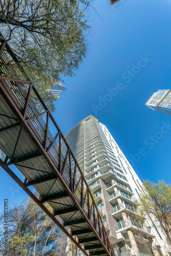 Downtown Austin, Texas- Footbridge in a low angle view near tge high-rise residential building photo