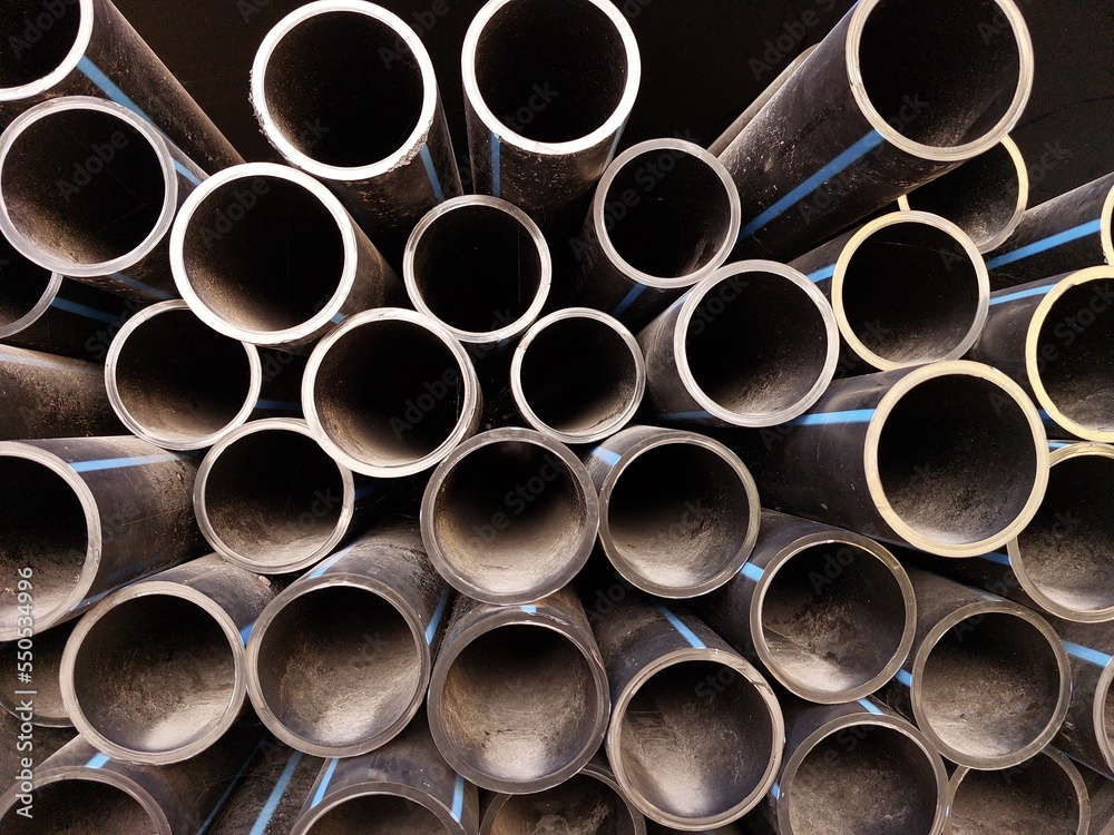 The stack of HDPE (high density polyethylene) pipes shot close up inside the warehouse The stack of HDPE (high density polyethylene) pipes shot close up inside the warehouse
