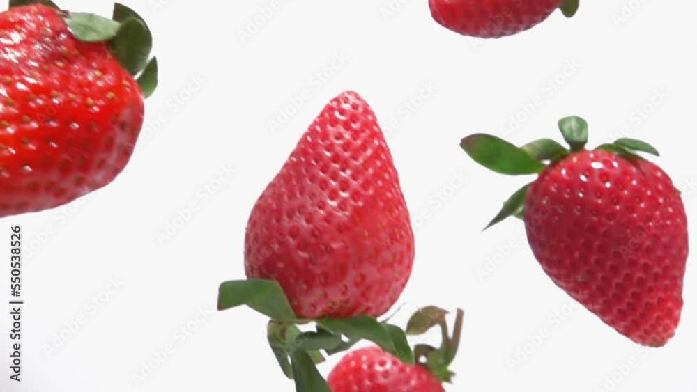 Close-up of the sweet red strawberries falling diagonally in super slow motion Close-up of the sweet red strawberries falling diagonally in super slow motion