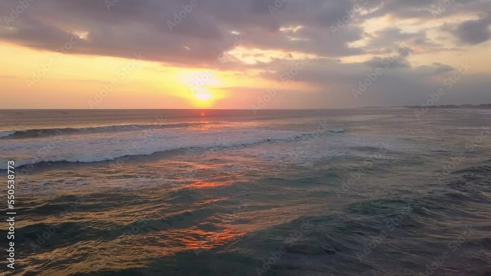 Cinematic drone shot. Sunset over ocean waves wash sand beach. Aerial sunset. Tropic nobody nature seascape. Paradise Bali island, Indonesia, Asia at sea bay Cinematic drone shot. Sunset over ocean waves wash sand beach. Aerial sunset. Tropic nobody nature seascape. Paradise Bali island, Indonesia, Asia at sea bay