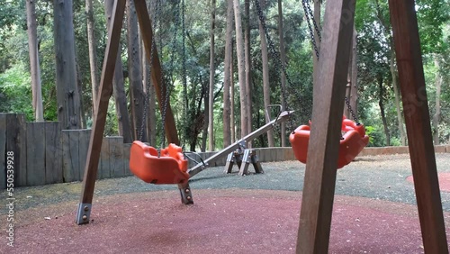 Empty swings in a park, 4k 60 fps video, children stay at home concept, nobody in child park, no people, empty playground
