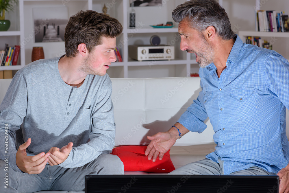 Fototapeta premium Two men at home arguing