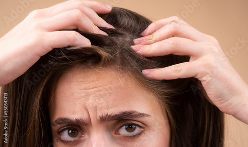 Young woman is very upset because of hair loss. Haircut and healthy haircare. Serious hair loss problem for health care shampoo.