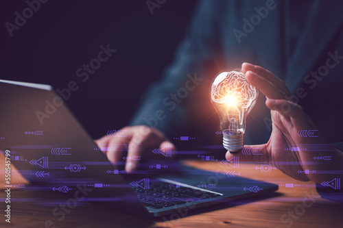 New idea innovation concept, man holding Light bulbs with Brain inside and digital connection line outside. Creative and innovation inspiration. Business Bright idea concept.