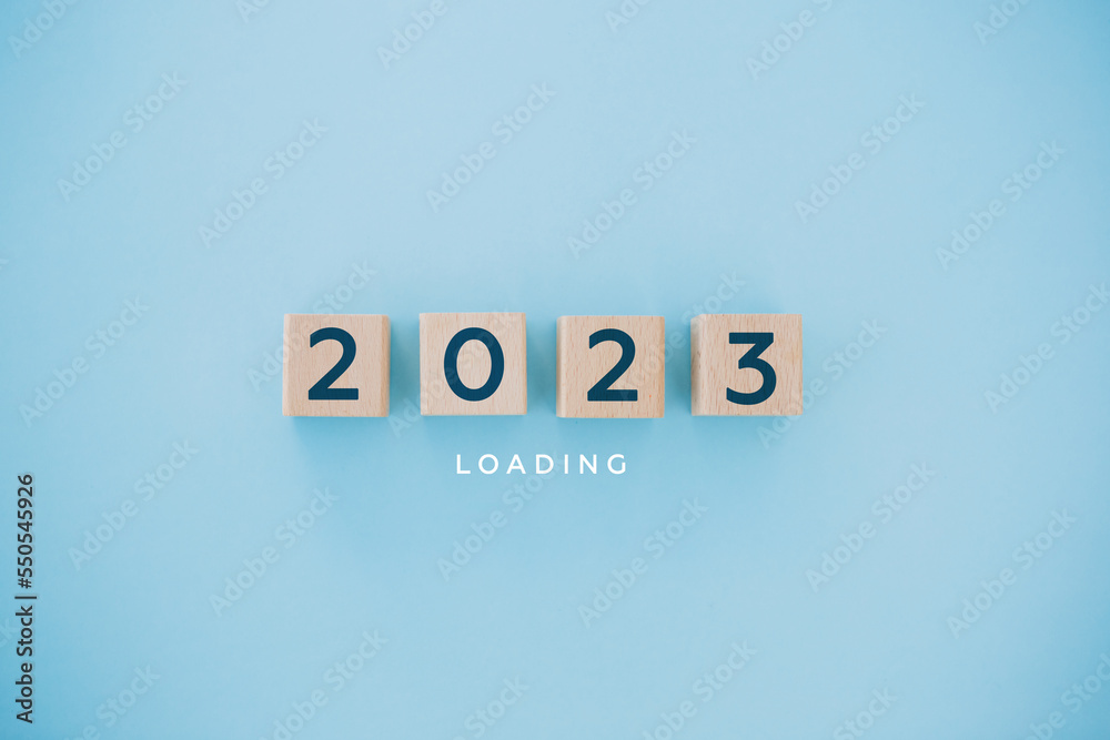 2023 New Year Loading. Loading bar with wooden blocks 2023 on blue background. Start new year 2023 with goal plan, goal concept, action plan, strategy, new year business vision.