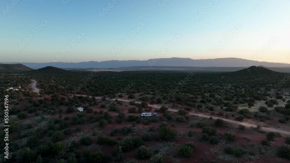 Camper Van On The Wild Desert Covered With Green Bushes Near Sedona, Arizona. Aerial Shot Camper Van On The Wild Desert Covered With Green Bushes Near Sedona, Arizona. Aerial Shot