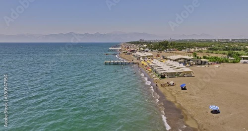 Antalya Turkey Aerial v28 low flyover long stretched lara beach capturing coastal activities and private luxury beach club with mountain silhouette on the skyline - Shot with Mavic 3 Cine - July 2022 photo