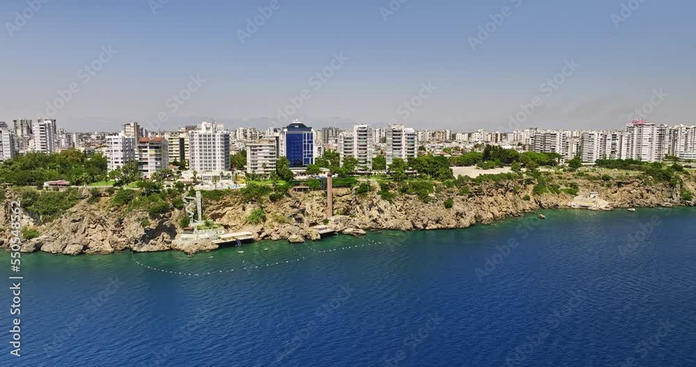 Antalya Turkey Aerial v1 reverse flyover mediterranean sea away from rugged cliff sirinyali residential neighborhood capturing urban cityscape with seafront condos - Shot with Mavic 3 Cine - July 2022 Antalya Turkey Aerial v1 reverse flyover mediterranean sea away from rugged cliff sirinyali residential neighborhood capturing urban cityscape with seafront condos - Shot with Mavic 3 Cine - July 2022