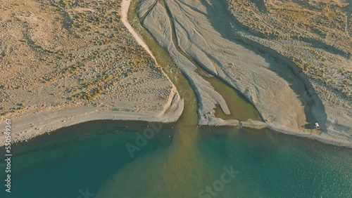 Beautiful aerial tilting shot of the Barrancoso River near Lake Strobel, Argentina photo