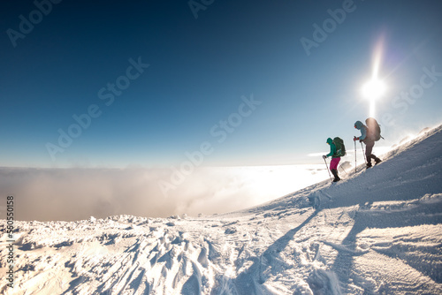climbers climb to the top of the mountain in winter