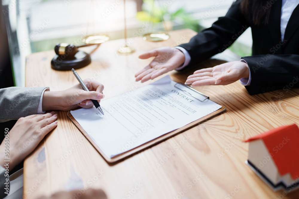 Guarantee, Mortgage, agreement, contract, Signing, Male client holding pen to reading agreement document to sign land loan with real estate agent or bank officer. Guarantee, Mortgage, agreement, contract, Signing, Male client holding pen to reading agreement document to sign land loan with real estate agent or bank officer.