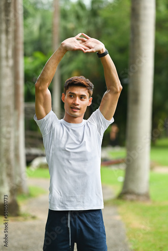 Portrait of asian male runner warm up before sports training outdoors. Fitness, sport and healthy lifestyle concept