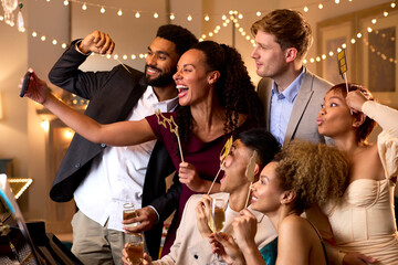 Group Of Friends Posing For Selfie Around Piano Celebrating At New Year Party Together