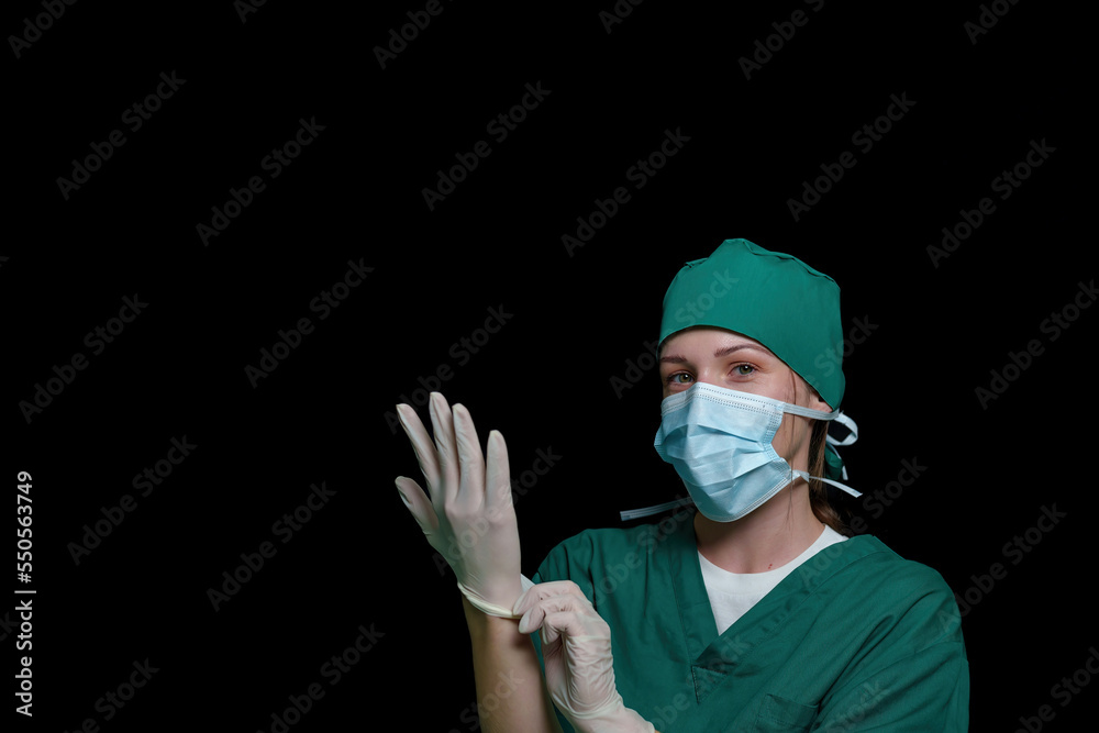 Doctor surgeon preparing makes an operation. Isolated on a black background.