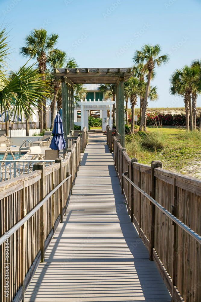Destin, Florida- Pathway with wooden handrails with pergola roofs Destin, Florida- Pathway with wooden handrails with pergola roofs