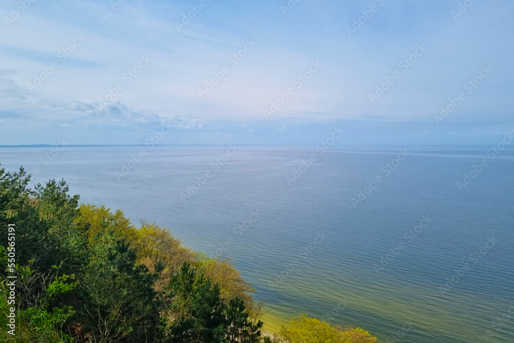 View from above to the sea. Blue transparent ocean water. Scenic background of nature. Water surface. Summer background. Rest on the sea.
