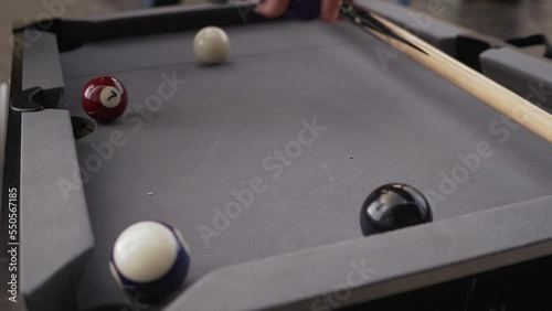 Taking back the pool balls to restart the game. photo