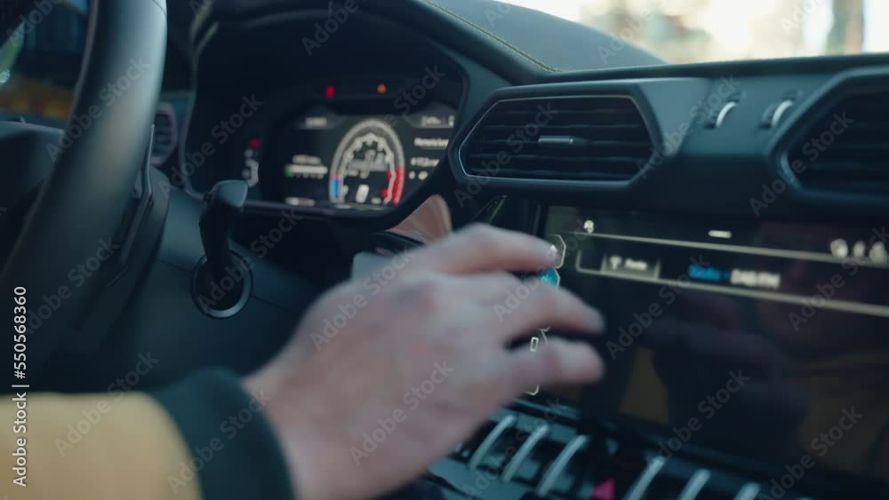 Person hand scrolling car touch screen choosing right function or adjusting navigation for road trip, close up shot of driver using digital dashboard for switching on and off or changing different