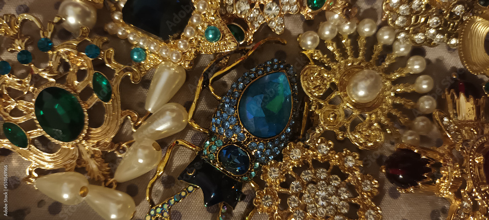Jewelry vintage at the flea market. Rare things, brooches with stones
