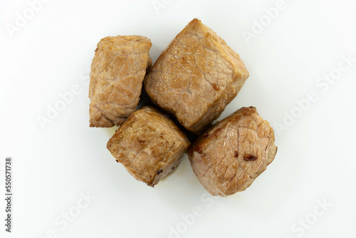 fresh baked meat cubes isolated on a white bacground top view