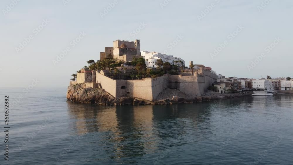 Peniscola Castle on a cliff overlooking the Mediterranean Sea - orbiting aerial view Peniscola Castle on a cliff overlooking the Mediterranean Sea - orbiting aerial view