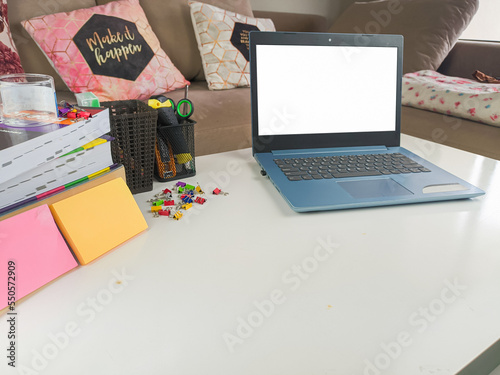 mockup image, laptop computer with blank screen in modern home room. with white space layout on a white table
