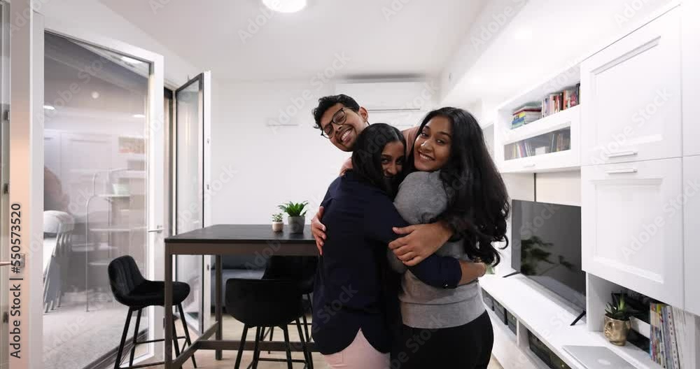 Laughing friends embracing in modern living room Laughing friends embracing in modern living room