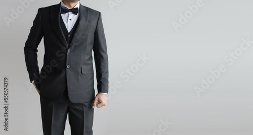 Detail half body close up a man black suit with vest inside with bow tie and white shirt.