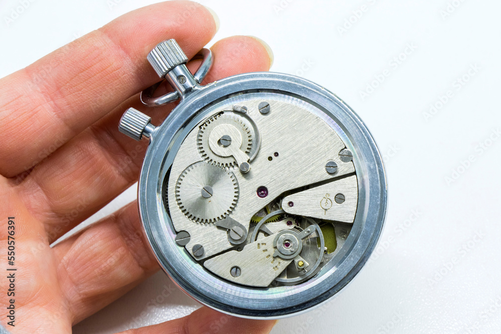 Old antiquary timer clock and humans hand Old antiquary timer clock and humans hand