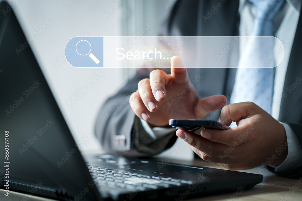 Search button on virtual screen. Search engine optimization, SEO.Businesswoman using laptop searching Browsing Internet Data Information.Networking Concept. Search button on virtual screen. Search engine optimization, SEO.Businesswoman using laptop searching Browsing Internet Data Information.Networking Concept.