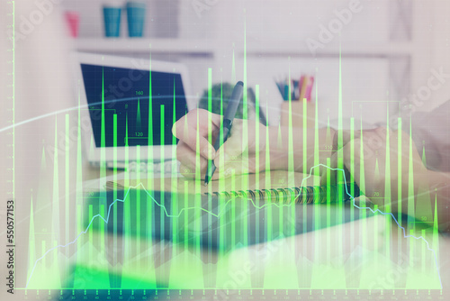 Financial graph displayed on woman's hand taking notes background. Concept of research. Double exposure © peshkova