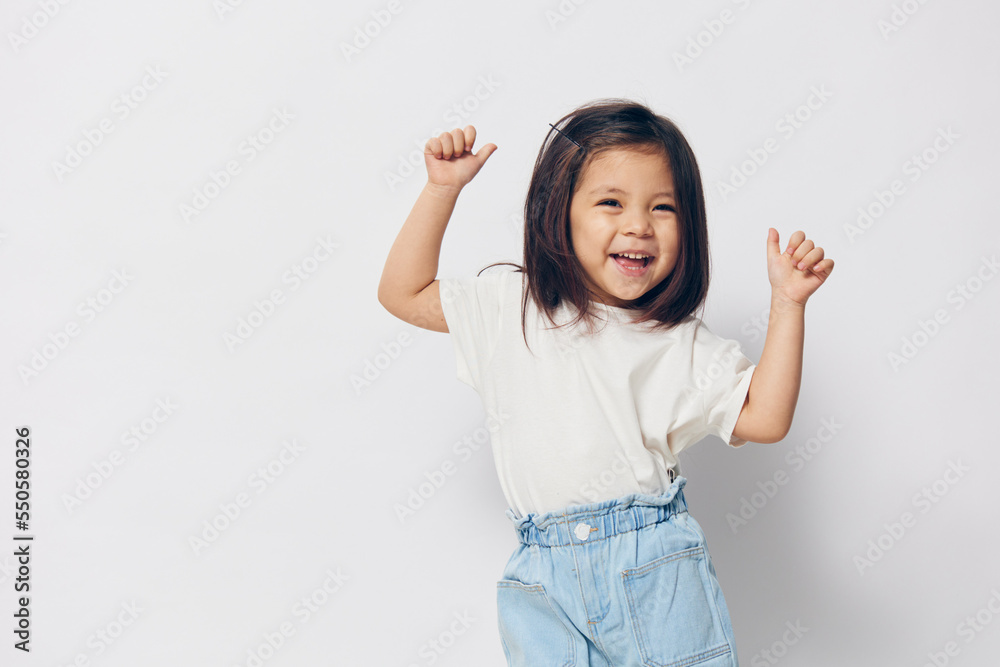 little joyful girl dancing on a light background little joyful girl dancing on a light background