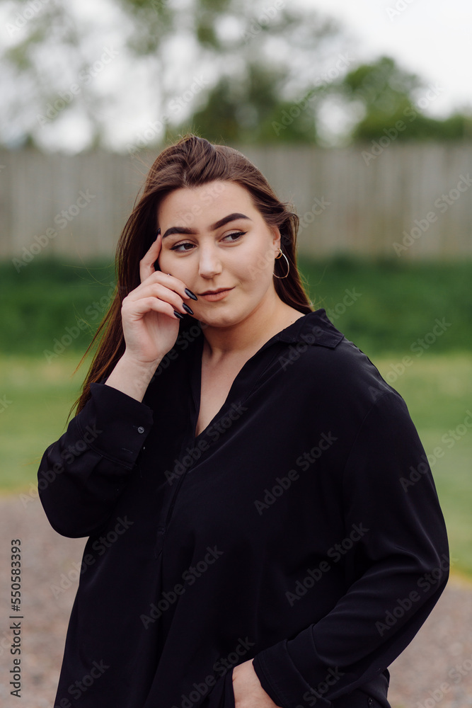 Beautiful friendly young woman with shoulder length brown hair posing outdoors Beautiful friendly young woman with shoulder length brown hair posing outdoors