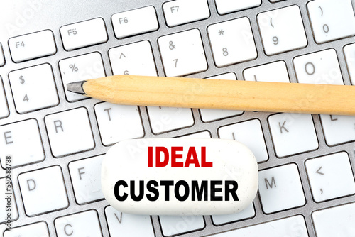 IDEAL CUSTOMER text on eraser with pencil on keyboard