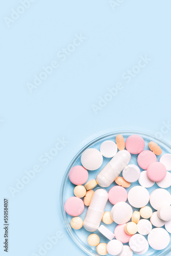 Medicine researching, pharmaceutical background.  Many different drugs, pills and tablets in a glass laboratory jar