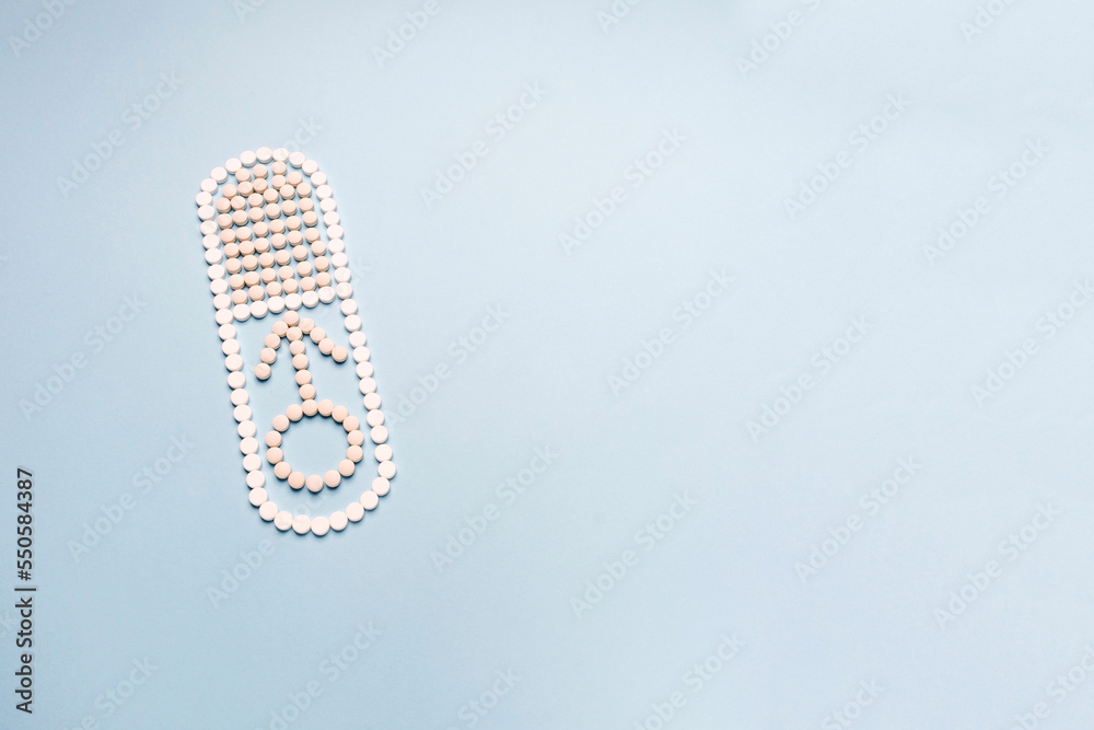 Men's health concept in November and September month. Concept of erection, potency. Treatment of male infertility and impotence. The capsule is made of pills and male symbol Men's health concept in November and September month. Concept of erection, potency. Treatment of male infertility and impotence. The capsule is made of pills and male symbol