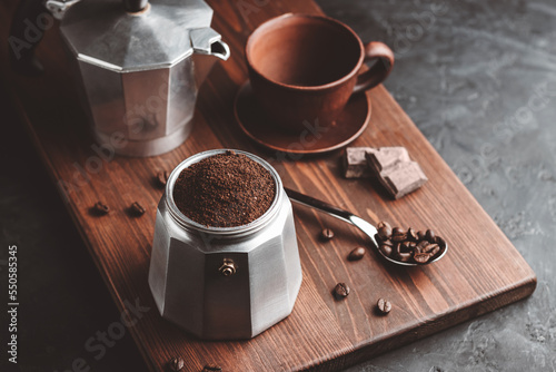 Print op canvas Moka coffee pot filled with brown ground coffee on dark wooden board, prepare to
