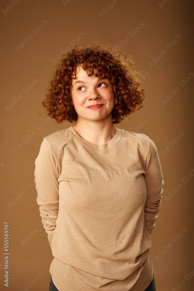 Portrait of a cute ginger girl with curly hair. Portrait of a cute ginger girl with curly hair.