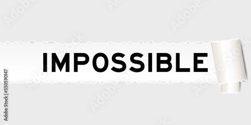 Ripped gray paper background that have word impossible under torn part