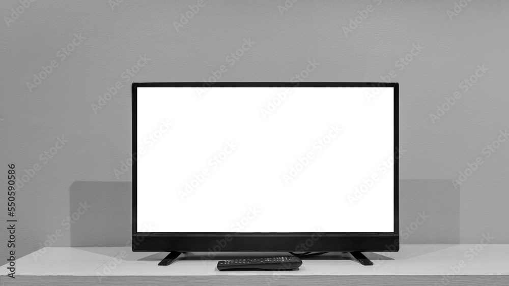 Flat LCD television on wood table in the living room with dark gray wall Flat LCD television on wood table in the living room with dark gray wall
