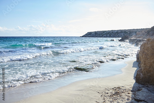 Sand beach, summer sea with blue sky. Sea water with white wave. Cala azzurra beach, Favignana island, Trapani, Sicily, Italy. A beautiful seascape