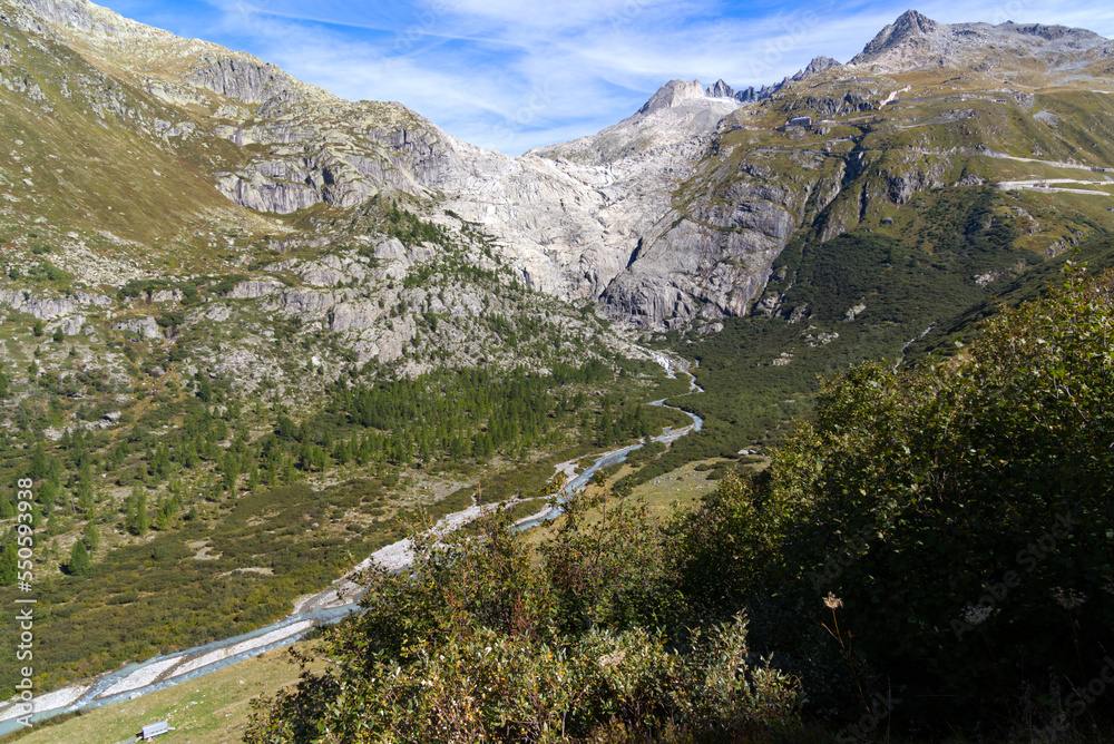 View of famous Rhone Glacier with Rhone River in the Swiss Alps with glacier river on a sunny late summer day. Photo taken September 12th, 2022, Furka Pass, Switzerland.