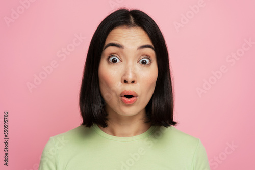 Surprised woman looking at camera with mouth open in amazement