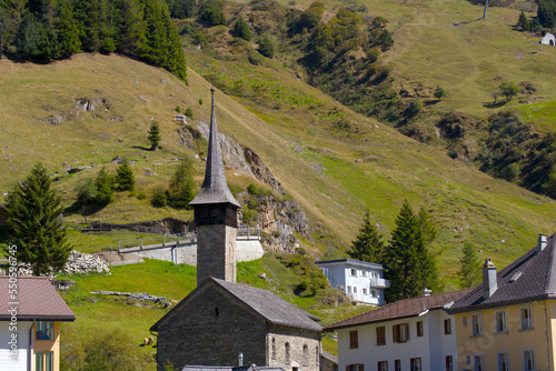 Roman style stone church named St. Kolumban at Swiss mountain village on a sunny late summer day. Photo taken September 12th, 2022, Andermatt, Switzerland. photo